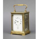 A French 8 day carriage alarm clock with enamelled dial, Roman numerals and alarm dial, contained in