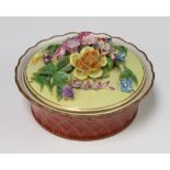 A 20th Century Dresden porcelain circular box and cover with applied flowers 14cm