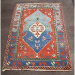 A blue and tan ground Caucasian style carpet 282cm x 201cm In wear, some signs of moth in places and