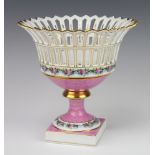 A 20th Century Dresden porcelain pierced pedestal bowl, the pink ground decorated with flowers 23cm