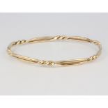 A 9ct yellow gold twist bangle, 13.9 grams This bangle is in good condition but one piece of strap