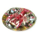 A Portuguese Palissy style wall plaque decorated with a lobster and shellfish 33cm This lot does
