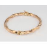 A 9ct yellow gold twist bangle, 7.4 grams Apart from minor scratches, this bangle is in good