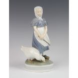 A Royal Copenhagen figure of a goose girl 527, 24cm