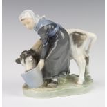 A Royal Copenhagen figure of a milkmaid with cow, 779 17cm