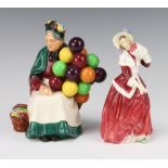 Two Royal Doulton figures - Christmas Morn HN1992 17cm and The Old Balloon Seller HN1315 19cm