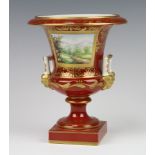 A modern Dresden porcelain urn with twin handles decorated with a landscape panel, raised on