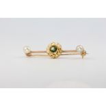 A 9ct yellow gold peridot and seed pearl bar brooch