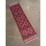 A red and blue ground Meshwani runner with 15 diamonds to the centre 240cm x 61cm