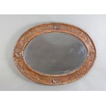 A Victorian oval bevelled plate wall mirror contained in a carved oak frame 68cm h x 92cm w