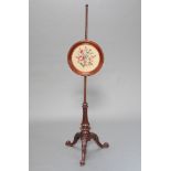 A William IV carved mahogany pole screen base raised on pillar and tripod supports with associated