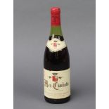 A bottle of 1982 Mazy Chambertin Domaine Armand Rousseau The wine is just above the top of the