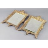 A pair of Victorian rectangular bevelled plate mirrors contained in a pierced gilt frames 39cm x