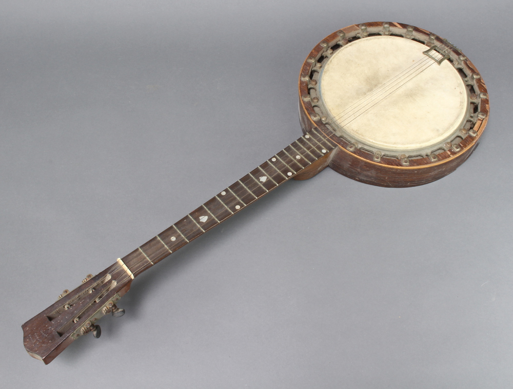 A 4 stringed banjo, the head marked The Windsor Popular Model no.7, back marked The New Windsor