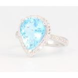A 14ct white gold pear cut blue topaz and diamond ring, the centre stone approx. 4.7ct surrounded by