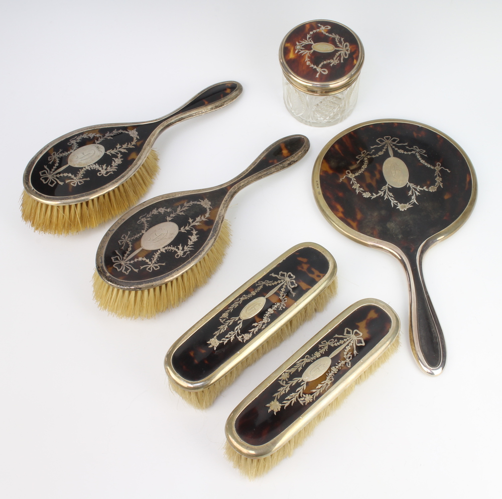 A George V silver and tortoiseshell piquet dressing table set comprising 2 hair brushes, 2 clothes