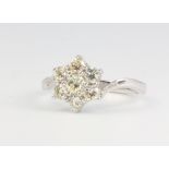 An 18ct white gold 7 stone diamond cluster daisy ring approx. 1ct, size Q, 4.8 grams