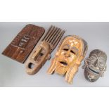 A carved African painted hardwood mask 30cm x 18cm together with 2 other masks and a hardwood