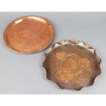 A Newlyn style circular planished copper tray with floral decoration 2cm x 29cm together with a