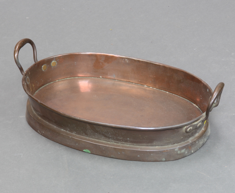 A 19th Century oval twin handled copper pan 8cm x 43cm x 30cm