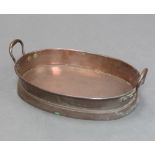A 19th Century oval twin handled copper pan 8cm x 43cm x 30cm