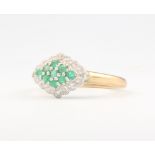 A 9ct yellow gold emerald and diamond cluster ring, 2.4 grams, size O