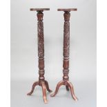 A pair of William IV carved mahogany bedpost torcheres raised on pillar and tripod bases 135cm h x