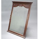 A 19th Century French arched bevelled plate over mantel mirror contained in a carved oak frame 123cm