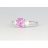 An 18ct white gold oval pink sapphire and diamond ring, the centre stone approx. 1.5ct, the diamonds