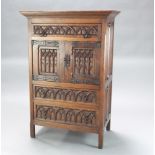 A 17th Century style carved oak Ipswich style cabinet, the upper section fitted a drawer above