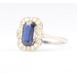 An Art Deco platinum, sapphire and diamond cocktail ring, the centre rectangular cut sapphire 10mm x