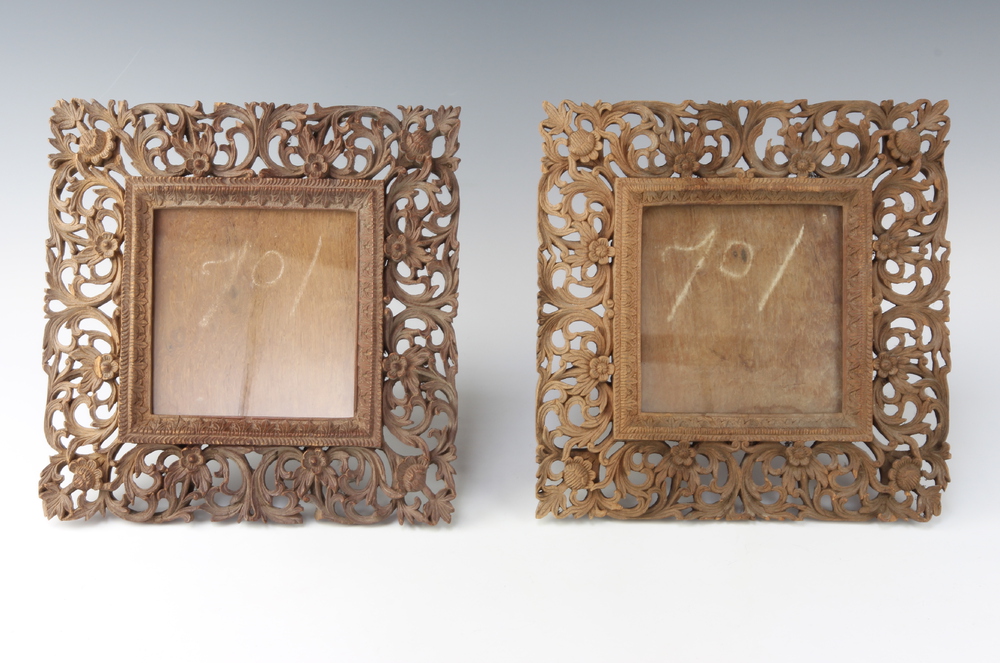 A pair of 19th Century carved and pierced Burmese hardwood easel photograph frames 30cm x 30cm