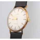 A gentleman's 9ct yellow gold Omega wristwatch, the dial inscribed Geneve, the reverse with