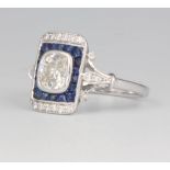 An 18ct white gold Art Deco style cocktail ring, the centre brilliant cut stone approx. 0.9ct