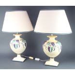 A pair of Continental pottery table lamps in the form of urns, raised on square bases 38cm x 17cm