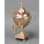 A Regency copper and brass tea urn with silver shield shaped cartouche and turned ivory handle,