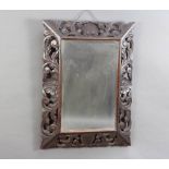 A Victorian rectangular plate mirror contained in a carved and pierced oak frame 59cm h x 80cm w