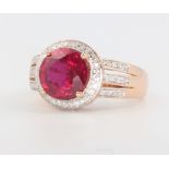 A 14ct rose gold ruby (treated) and diamond cluster ring, the centre stone approx. 4ct, the diamonds