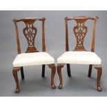 A pair of 19th Century Chippendale style slat back dining chairs with pierced vase shaped slat backs