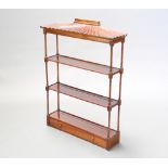 A Regency style rectangular mahogany 3 tier hanging wall shelf with shaped canopy raised on turned