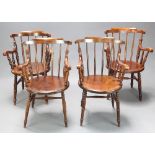 A set of 4 19th Century beech framed stick and rail back Windsor carver chairs raised on ring turned