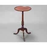 An Edwardian, Georgian style circular mahogany dish top wine table raised on a turned column and