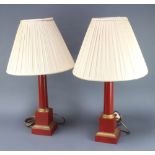 A pair of red and gilt painted metal column standard lamps complete with shades 40cm h x 13cm x 13cm