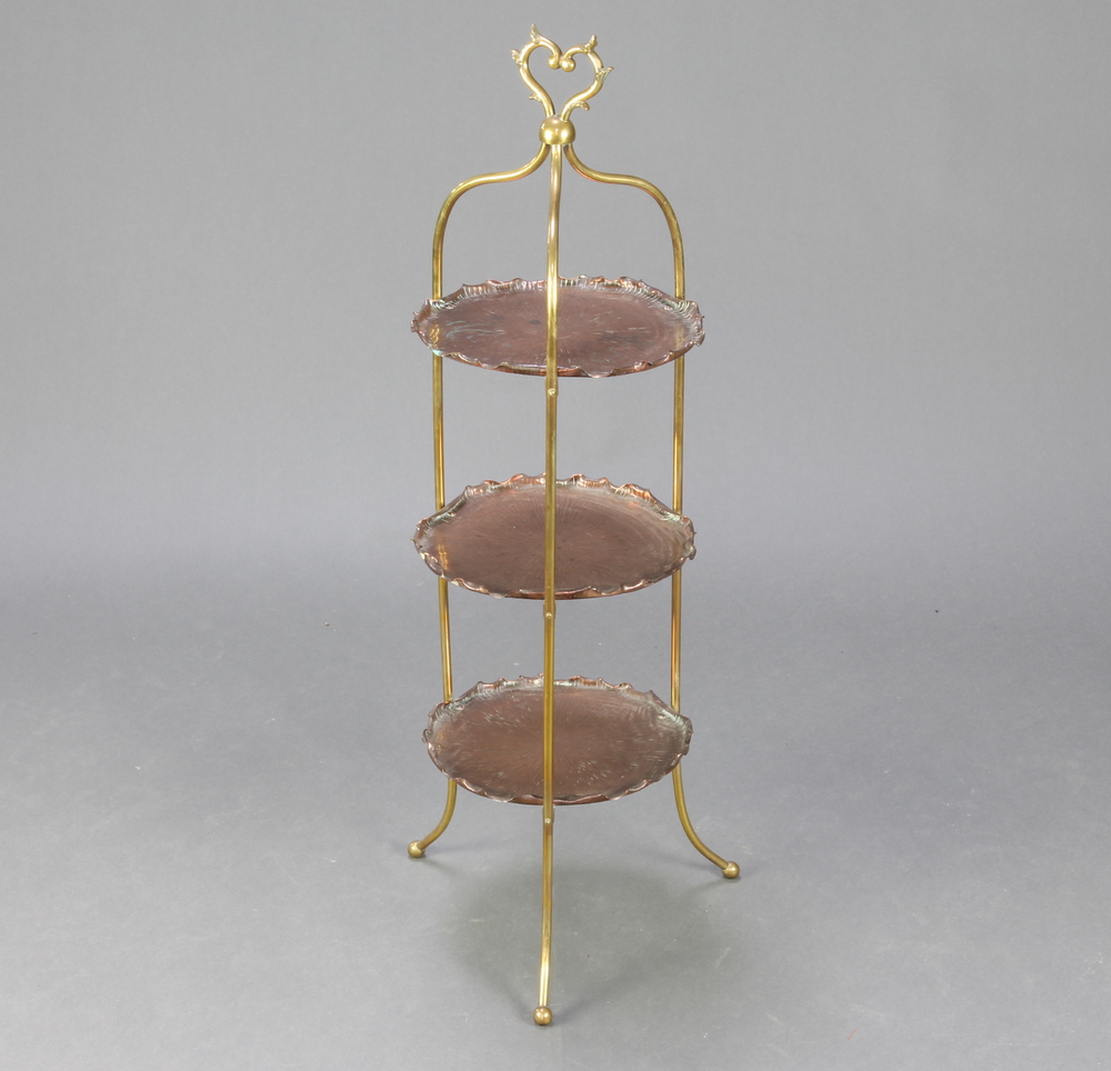 A Victorian copper and brass 3 tier cake stand raised on outswept supports 91cm h x 26cm w