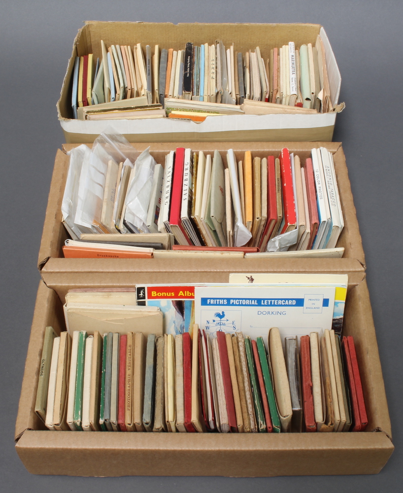 Three shallow boxes of 1950's black and white and coloured miniature postcards