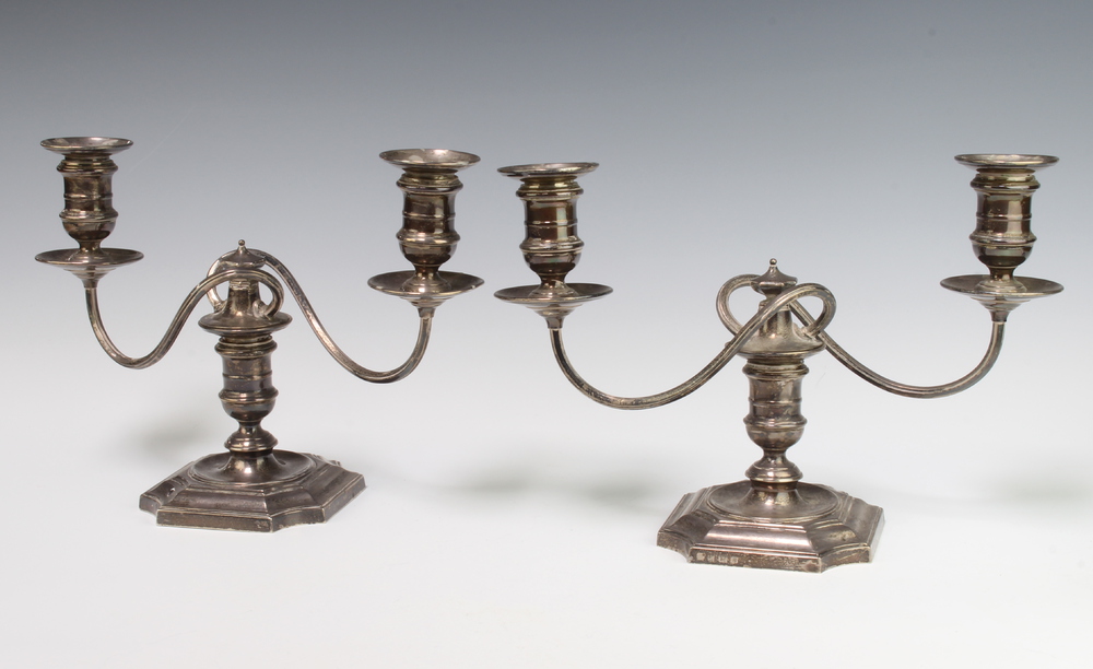 A pair of 2 light silver candlesticks with scroll arms, Birmingham 1934, weighted, gross weight 1800