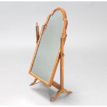 A 1930's Queen Anne style arched plate dressing table mirror contained in a walnut swing frame