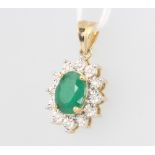A 9ct yellow gold oval emerald and diamond cluster pendant 0.12ct of diamonds, approx 2ct emerald,