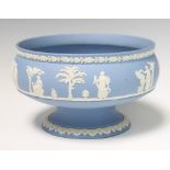 A Wedgwood blue Jasperware pedestal bowl decorated with figures before trees 22cm