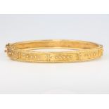 An Edwardian 9ct yellow gold Etruscan style bangle 10 grams